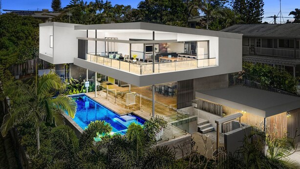 A modern two-story house with a rooftop deck, a swimming pool, and lush greenery. - Blueys Beach House - 4 bedroom (Sunrise Beach)