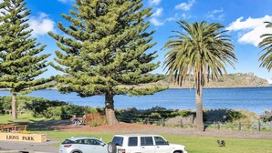 A park with a white car parked near a sign that reads "LIONS PARK". - Beautiful Beach Front Townhouse (Victor Harbor)