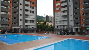 A swimming pool surrounded by high-rise residential buildings.