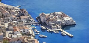 A coastal town with stone buildings, a marina, and boats. - Cozy sea view apt. with heated pool and football court (Kaštel Stari)