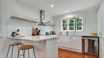 Enjoy meals and snacks at the central island with seating and a stainless steel dishwasher.