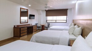 A hotel room with two beds, a wooden dresser, a desk, a chair, a television, and a window with a view. - Hotel San Lucas (Mexico City)