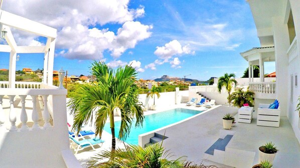 Relax by the pool surrounded by lush greenery and breathtaking mountain views.