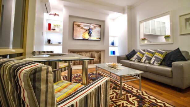 A living room with a sofa, armchairs, a coffee table, and a patterned rug. - M107 CBD Location near Kings Park  (West Perth)