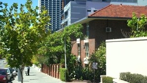 A residential street with modern buildings, a sidewalk, and parked cars. - M107 CBD Location near Kings Park  (West Perth)