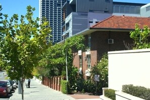 Stroll through a serene neighborhood with a mix of modern and traditional architecture.
