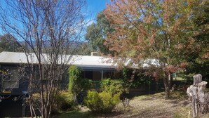 A house with a metal roof, surrounded by trees and shrubs. - View Mount - Families and small groups (Merrijig)