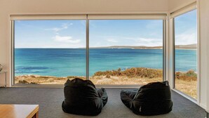 A room with large windows overlooking a coastal view. - Tranquility Bay of Fires - A beautiful beach house in a stunning location (The Gardens)