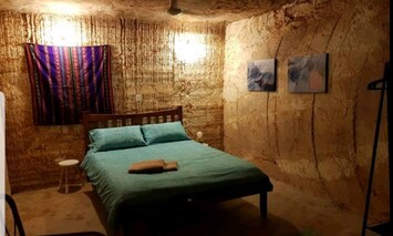 Huge room with seated area and large window and fan - an Adult space!