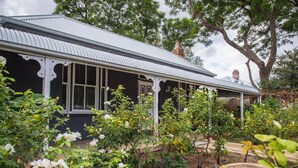A house with a dark facade, white window frames, and a metal roof. - Perfect Location for Leisure or Business - Right in the main street (Scone)
