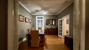 A hallway with a dining table and chairs, a ceiling fan, and a door leading to another room. - Perfect Location for Leisure or Business - Right in the main street (Scone)