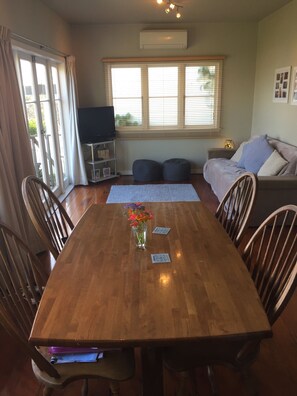 Relax in this spacious living area with a dining table, flat-screen TV, and comfortable sofa.