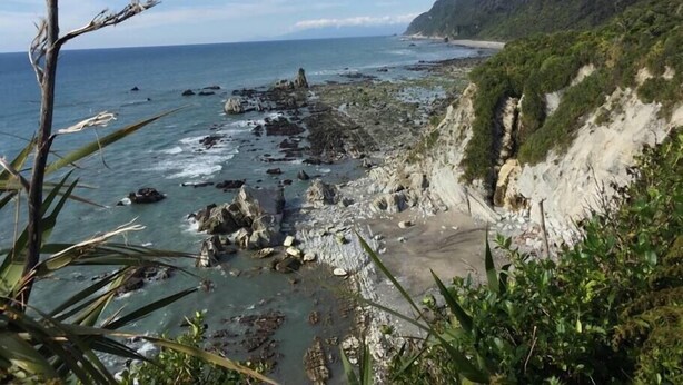 A coastal landscape with rocky shores, a clear sky, and a distant view of the ocean. - Home by the Beach with sensational view! Pet-friendly. (Westport)