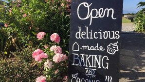 A sign advertising a bakery with baking and organic options. - Home by the Beach with sensational view! Pet-friendly. (Westport)