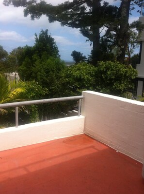 Enjoy breathtaking views of the surrounding landscape from this balcony.