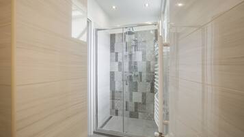 Shower, hair dryer, towels, shampoo