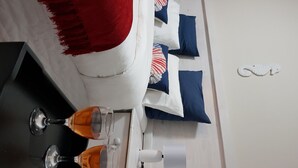 A neatly arranged hotel room with a bed, pillows, a bedside table, and a lamp. - Seboa Accommodation (Guesthouse and Self Catering) (Vineta)