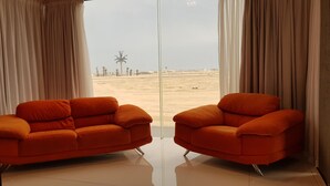 A room with two orange armchairs facing a large window. - Seboa Accommodation (Guesthouse and Self Catering) (Vineta)