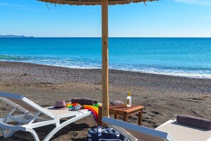 On the beach, sun loungers, beach towels