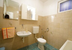 A bathroom with a sink, toilet, and mirror. - Apps Maria: place to spend holidays with friends & family in Split (Croatia) (Podstrana)