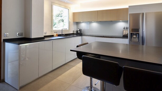A modern kitchen with a central island, stainless steel appliances, and a window providing natural light. - High end estate with superb sea view, heated swimming pool, tennis, jacuzzi (Hyères)