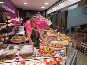 A bakery display case with various pastries and desserts.