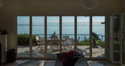 Suuri lomamökki, josta on upeat näkymät rannalle ja erillinen majatalo nukkuu 12