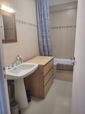 Bathtub, towels, soap, toilet paper