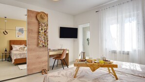 A modern bedroom with a bed, a desk, a TV, and a breakfast setup. - Beautiful **** villa with heated pool, summer kitchen, WiFi, grill, fitness, 1.5 km from the sea (Pula)