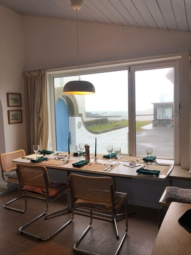 Bright modern holiday cottage steps from the beach and in the heart of village