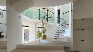 A spacious interior with a modern staircase, a large window, and a minimalist design. - South facing Villa with Panoramic Sea View, POOL, AC, Quiet  (Grasse)