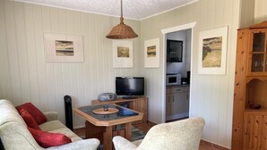 A cozy living room with a TV, a small table, and two armchairs. - Relaxing holiday in the detached house Selma! (Trassenheide)