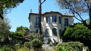 A two-story building with a curved facade, multiple windows, and a balcony. - House / Villa - SANARY SUR MERHouse with character (Sanary-Sur-Mer)