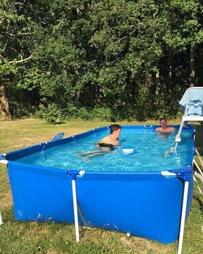 An above-ground swimming pool with two people swimming. - Apartment I" between Bordeaux and the Atlantic "Mimosa" (Brach)