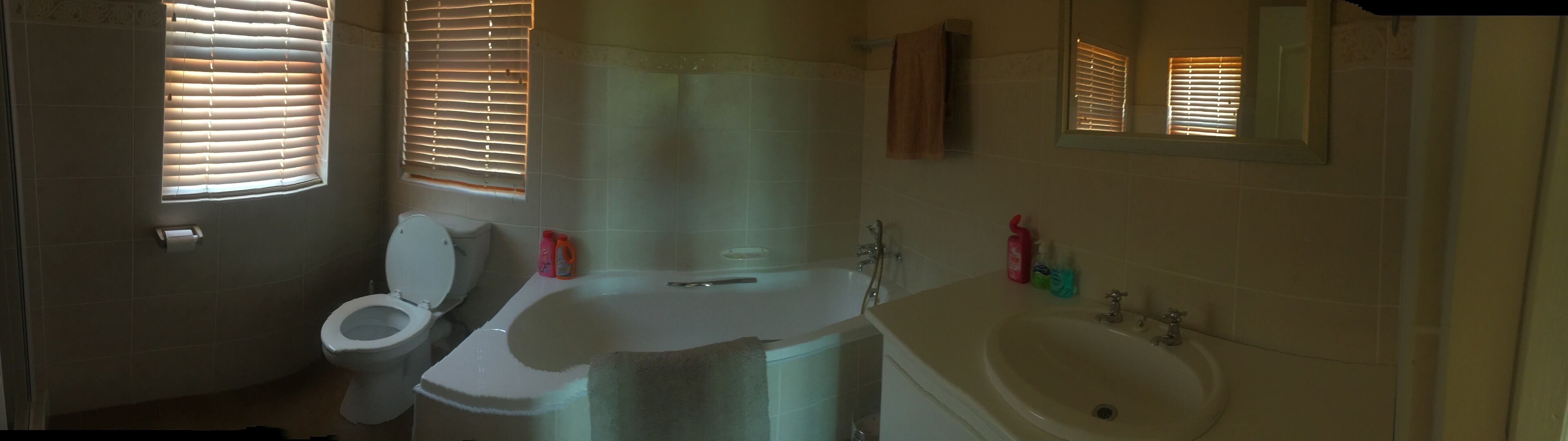 A bathroom with a toilet, sink, and bathtub.