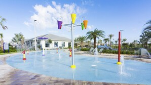 A water play area with multiple colorful water jets and a tiled floor. - Fabulous Apartment with balcony at Storey Lake 272977 (Kissimmee)