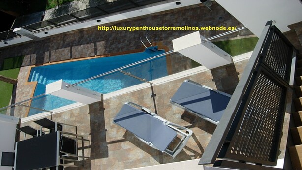 A rooftop pool with a glass enclosure, lounge chairs, and a view of the surrounding area. - OFFERS FOR LAST DAYS!!, LUXURY ATTIC CARIHUELA,  2 GARAGES, POOL, INT. CHANNELS (Torremolinos)