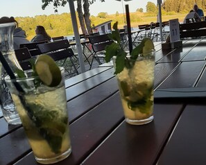 Two glasses of a beverage with mint leaves on a table outdoors. - Bright apartment Heidi 1st floor with fantastic valley view: KOLVENBACHER ZIEGENHOF (Kolvenbach)