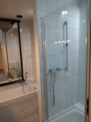 Bathtub, hair dryer, towels, soap