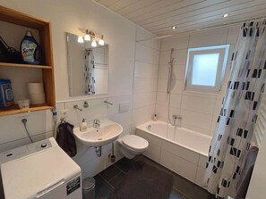 Bathtub, hair dryer, towels, soap