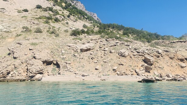 A rocky coastline with clear blue waters.