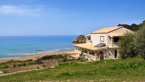 A coastal house with a balcony overlooking the beach, a small garden, and a clear view of the sea. - Beach house Tolis at Pelekas Beach (Pelekas Κέρκυρα)