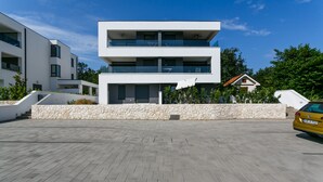 A modern multi-story building with a stone facade and a flat roof. -  Relax with a view of the sea !! (Vantacici-Malinska)