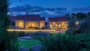 A two-story house with a tiled roof, a covered patio, and a landscaped garden. - Villa Gardena with heated pool (Kvarner - Vrh) (Vrh)