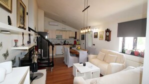 A modern living room with a staircase, a dining area, and a kitchen. - Peaceful Haven - 3BR/1BA Apt, Sleeps 5, Parking 1 (Banjole)