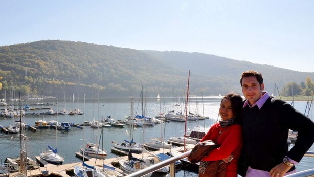 A marina with boats docked, a clear sky, and a hilly landscape in the background. - Pure relaxation with steam shower and whirlpool in a comfort cottage  (Bad Berleburg)