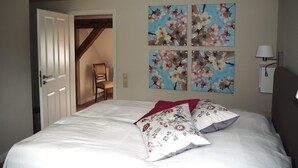 A bedroom with a bed, a chair, and a door. - Villa holiday Stintenburg island in the Biosphere (Zarrentin am Schaalsee OT Stintenburg)