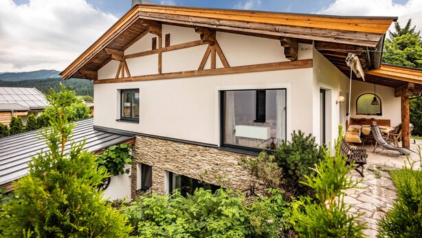 A modern house with a stone foundation, wooden beams, and large windows. - SKI IN - SKI OUT at the Eichenhof ski lifts (St.Johann In Tirol)