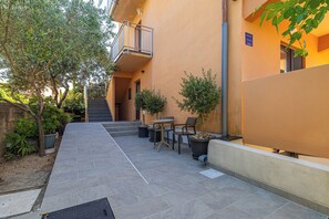 A courtyard with a staircase, outdoor seating, and potted plants. - Suite& Pool (without kitchen) (malinska)
