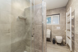 Shower, towels, soap, toilet paper